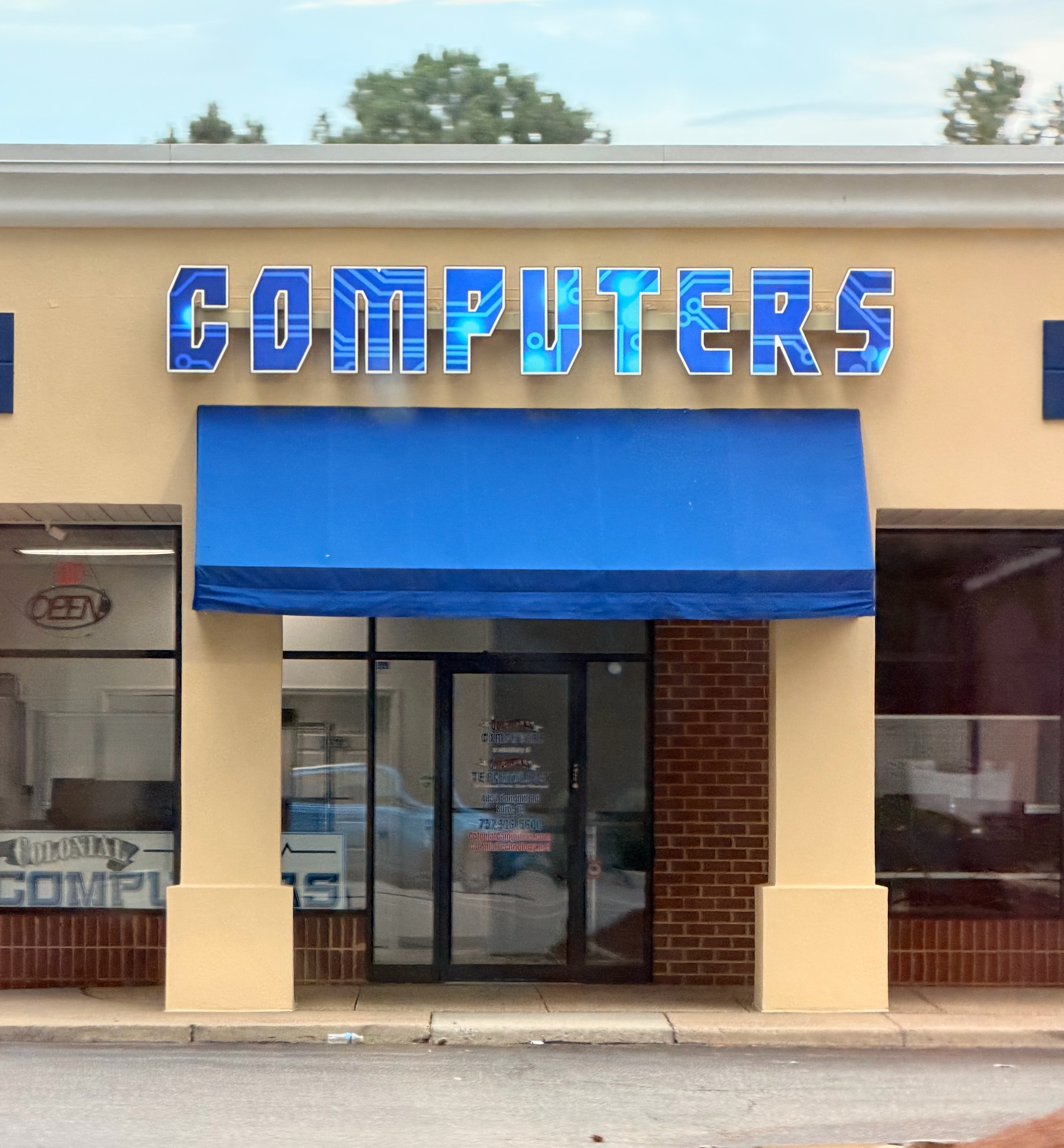 A store that has a sign that simply says “COMPUTERS” with microchip design