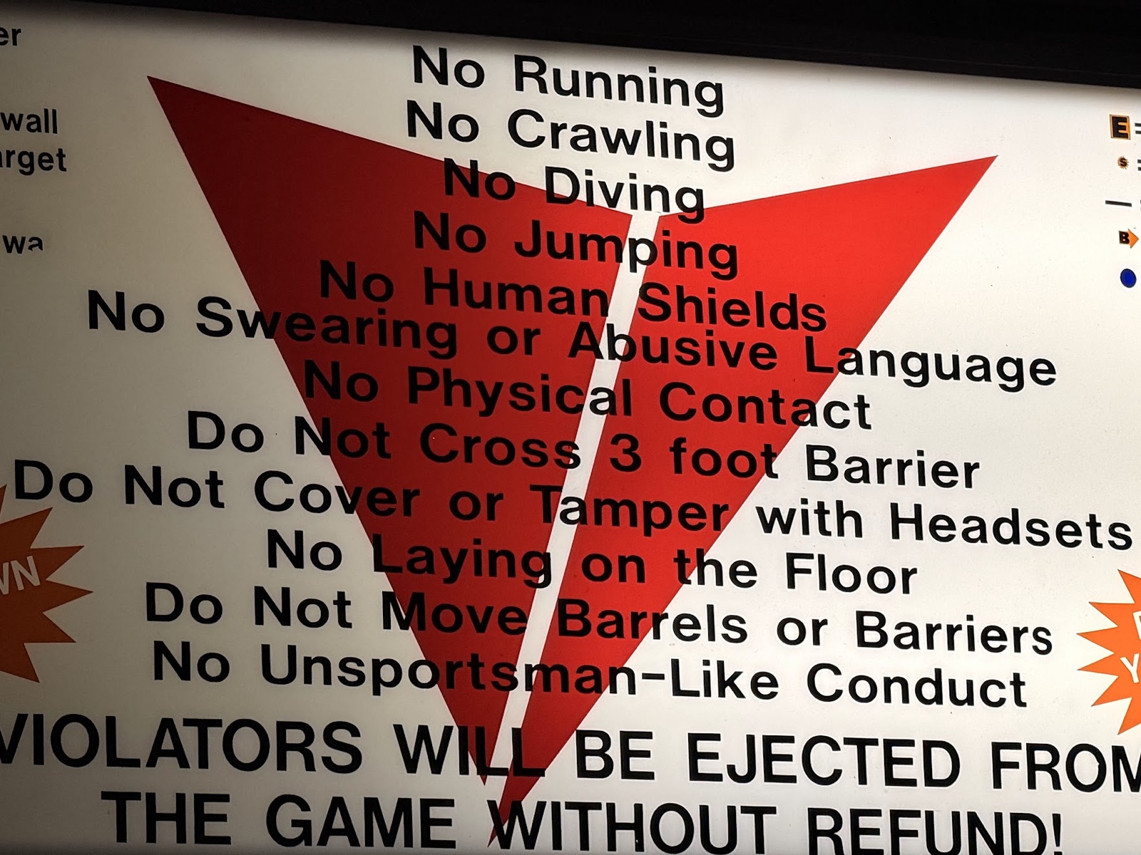 An illuminated rules sign listing No Running, No Crawling, No Diving, No Jumping, No Human Shields, and more, ending with "Violators will be ejected from the game without refund!"
